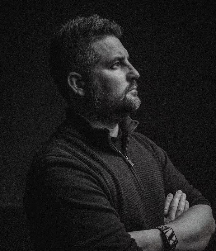 Black and white portrait of Graeme Watt, arms crossed